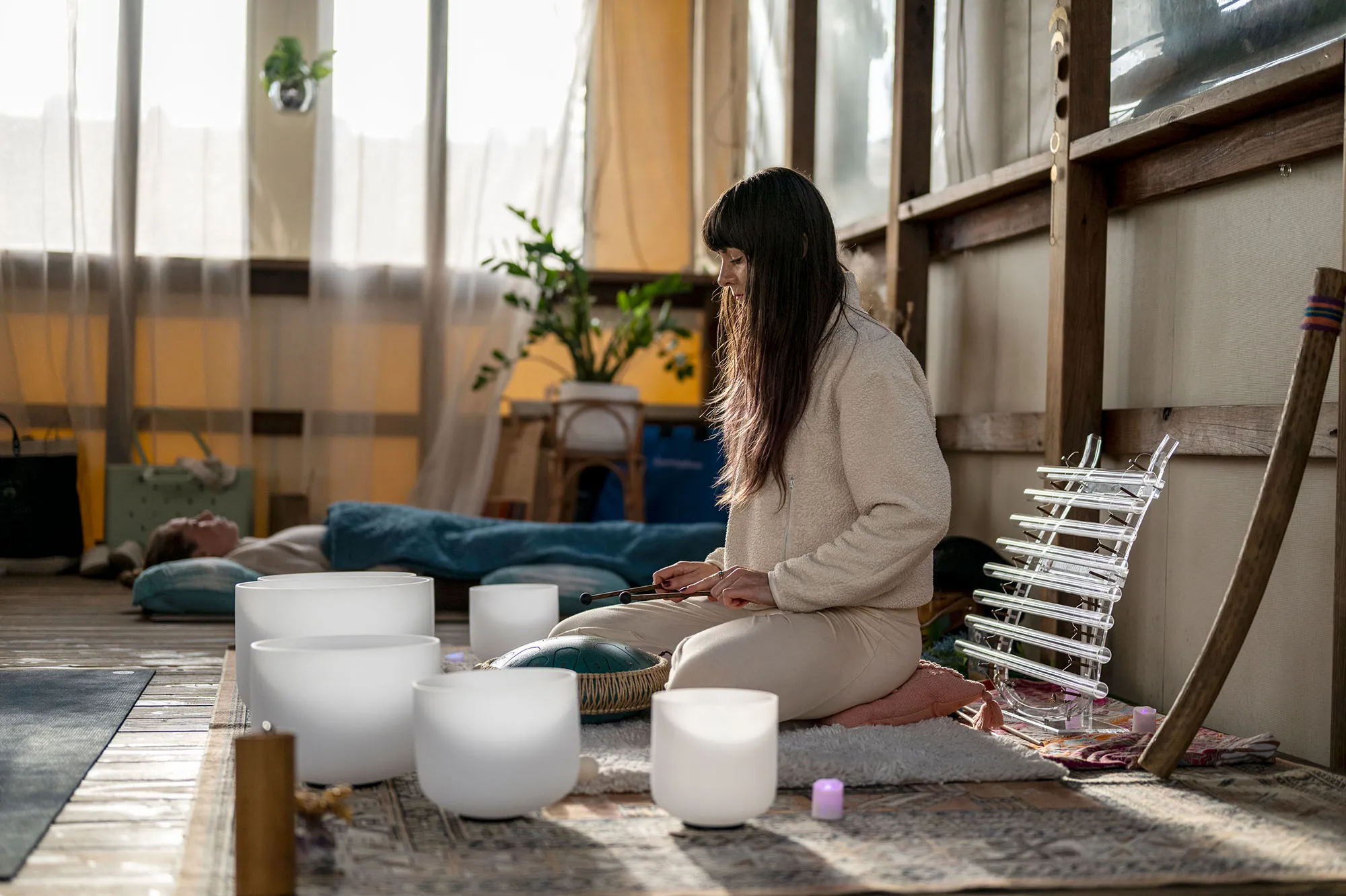 Lola Lovebyrd playing crystal singing bowls